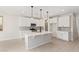 Modern kitchen featuring white cabinetry, quartz countertops, and an island at 11519 S 50Th Ave, Laveen, AZ 85339