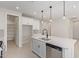 Modern kitchen island with sink, dishwasher, and white cabinets at 11519 S 50Th Ave, Laveen, AZ 85339