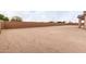 Large, empty backyard space, enclosed by a brick wall, offering potential for landscaping and customization at 19655 E Estrella Rd, Queen Creek, AZ 85142