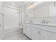 Bright bathroom featuring double sinks, a large vanity, and a shower with tub at 19655 E Estrella Rd, Queen Creek, AZ 85142