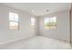 Bright bedroom with three windows showcasing natural light and neutral color palette at 19655 E Estrella Rd, Queen Creek, AZ 85142