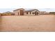 Wide backyard showing house with neutral colored exterior and large lot, enclosed by fencing at 19655 E Estrella Rd, Queen Creek, AZ 85142