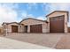 Beautiful home featuring multiple garages, stone accents, and a paver driveway enhancing its curb appeal at 19655 E Estrella Rd, Queen Creek, AZ 85142