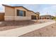 Attractive home with a well-kept desert landscape, complemented by stone accents and a manicured lawn at 19655 E Estrella Rd, Queen Creek, AZ 85142