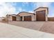 Stunning home featuring a 4-car garage and a driveway paved with decorative stone at 19655 E Estrella Rd, Queen Creek, AZ 85142