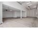 Spacious, clean garage featuring an attached door, bright lighting, and a sealed concrete floor at 19655 E Estrella Rd, Queen Creek, AZ 85142