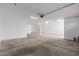 Clean, spacious garage with bright lighting, featuring sealed concrete flooring and multiple outlets at 19655 E Estrella Rd, Queen Creek, AZ 85142