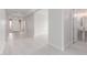 Open hallway with view of front door, access to bathroom and plenty of natural light at 19655 E Estrella Rd, Queen Creek, AZ 85142