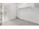 Bright walk-in closet with shelves and a hanging rod situated across from Primary bathroom at 19655 E Estrella Rd, Queen Creek, AZ 85142