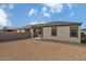 Spacious backyard with block wall, covered patio, and desert landscaping at 5729 S 243Rd Dr, Buckeye, AZ 85326