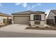 Charming single-story home with a tile roof, a two-car garage, and low-maintenance landscaping at 5729 S 243Rd Dr, Buckeye, AZ 85326