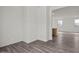 Bright living room with wood-look floors, neutral walls, and an open floor plan at 5729 S 243Rd Dr, Buckeye, AZ 85326