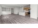 Open-concept living area with wood-look floors, a kitchen, and ample natural light at 5729 S 243Rd Dr, Buckeye, AZ 85326
