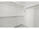 Walk-in closet with carpet, a closet rod, and shelves on multiple walls at 5729 S 243Rd Dr, Buckeye, AZ 85326
