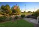 Backyard with grass, patio, and view of baseball field at 1521 W Commerce Ave, Gilbert, AZ 85233