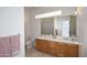 Bathroom with double vanity, large mirror, and shower at 1521 W Commerce Ave, Gilbert, AZ 85233