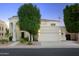 Two-story home with white exterior, landscaping, and three-car garage at 1521 W Commerce Ave, Gilbert, AZ 85233