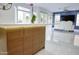 Kitchen island with wood cabinets and quartz countertop at 1521 W Commerce Ave, Gilbert, AZ 85233