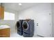 Laundry room with washer and dryer, built-in cabinets at 1521 W Commerce Ave, Gilbert, AZ 85233