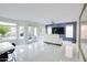 Bright living room with white sofa and large TV at 1521 W Commerce Ave, Gilbert, AZ 85233