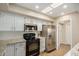 Updated kitchen boasts white cabinets, granite countertops, and stainless steel appliances at 9140 W Kimberly Way, Peoria, AZ 85382