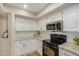 Bright kitchen features white cabinets, granite counters, and stainless steel appliances at 9140 W Kimberly Way, Peoria, AZ 85382