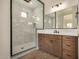 Bathroom featuring a spacious walk-in shower with glass door and wood cabinets at 19679 E Estrella Rd, Queen Creek, AZ 85142