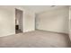 Bedroom with neutral carpeting, access to an ensuite bathroom, and a view of the hallway at 19679 E Estrella Rd, Queen Creek, AZ 85142
