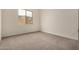Bedroom with neutral carpeting and a window overlooking the neighborhood at 19679 E Estrella Rd, Queen Creek, AZ 85142