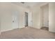 Bedroom featuring neutral carpeting and views into the hallway and closet space at 19679 E Estrella Rd, Queen Creek, AZ 85142