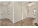 Inviting entryway with stylish wood-look tile flooring and neutral walls leading to the front door at 19679 E Estrella Rd, Queen Creek, AZ 85142