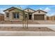 Charming single-story home featuring stone accents and a well-manicured yard at 19679 E Estrella Rd, Queen Creek, AZ 85142