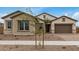 Charming single-story home featuring stone accents, neutral stucco, and a well-manicured front yard at 19679 E Estrella Rd, Queen Creek, AZ 85142