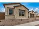 Charming home featuring stone accents, an inviting facade, and manicured landscaping at 19679 E Estrella Rd, Queen Creek, AZ 85142