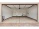 Spacious garage featuring an automatic door, ample lighting, and easy access to a water heater at 19679 E Estrella Rd, Queen Creek, AZ 85142