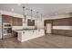 Spacious kitchen featuring an island with white countertop, wood cabinets, and stainless steel appliances at 19679 E Estrella Rd, Queen Creek, AZ 85142
