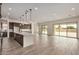 Open concept living space with large kitchen island, tile floors, and access to the back patio at 19679 E Estrella Rd, Queen Creek, AZ 85142