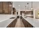 Open kitchen with gas range, island with breakfast bar, quartz countertops, and wood cabinetry at 19679 E Estrella Rd, Queen Creek, AZ 85142