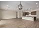 Open concept living area with tile floors, kitchen, dining, and lighting fixture at 19679 E Estrella Rd, Queen Creek, AZ 85142