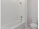 This bathroom has white tiled walls, a shower head, and a white toilet at 21921 S 197Th St, Queen Creek, AZ 85142