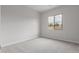 This bedroom features neutral carpeting and a large window for plenty of natural light at 21921 S 197Th St, Queen Creek, AZ 85142