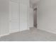 This bedroom features neutral carpeting and a double-door closet at 21921 S 197Th St, Queen Creek, AZ 85142
