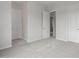 This bedroom has neutral carpet flooring and three doors leading to other parts of the home at 21921 S 197Th St, Queen Creek, AZ 85142