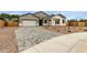 Charming single-Gathering home featuring a stone-accented facade and a patterned brick driveway at 21921 S 197Th St, Queen Creek, AZ 85142