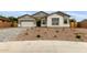 Charming single-story home featuring a two-car garage and desert landscaping in front at 21921 S 197Th St, Queen Creek, AZ 85142