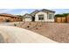 Inviting home with gravel front yard, and a paved walkway leading to the entrance at 21921 S 197Th St, Queen Creek, AZ 85142