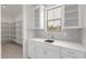 Kitchen featuring white cabinets, a stylish backsplash, stainless steel sink and a convenient pantry at 21921 S 197Th St, Queen Creek, AZ 85142
