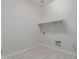 A blank laundry room ready for your ideas with tile flooring and a shelf at 21921 S 197Th St, Queen Creek, AZ 85142