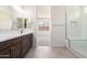 Stylish bathroom featuring a dual sink vanity, glass-enclosed shower and neutral finishes at 17225 W Calle Lejos --, Surprise, AZ 85387