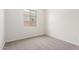 Neutral bedroom with carpet floors, white walls and bright window at 17225 W Calle Lejos --, Surprise, AZ 85387